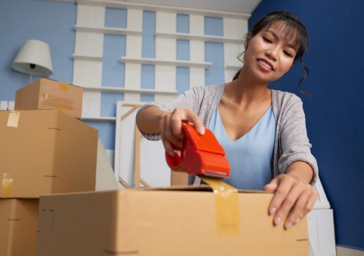 Woman Sealing Moving Box