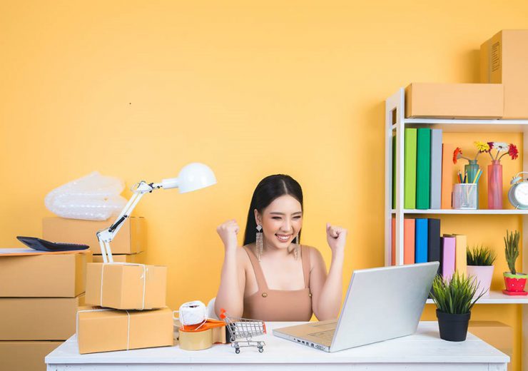 business owner working at home office packaging on background.